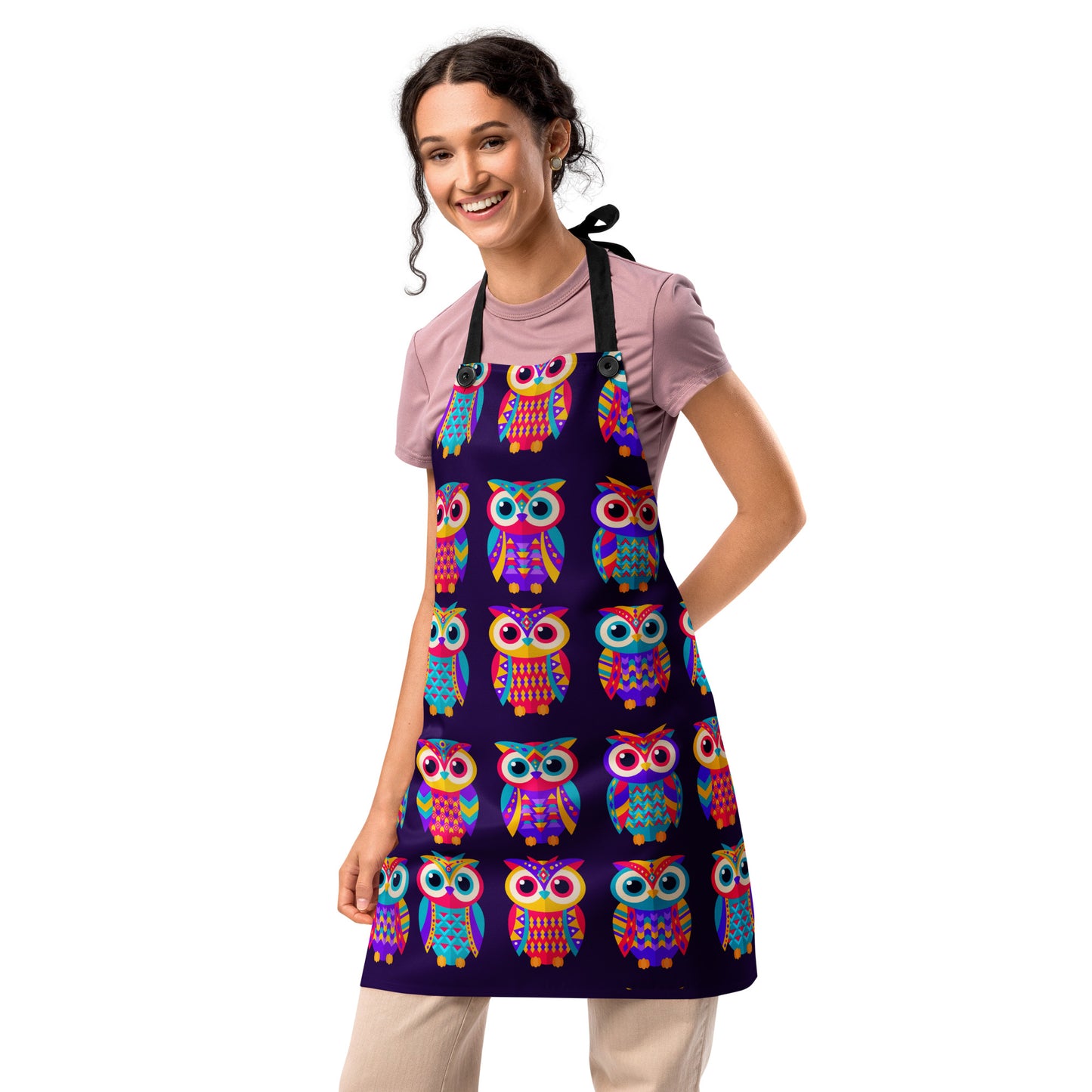 Woman wearing a colorful owl-patterned apron on a white background