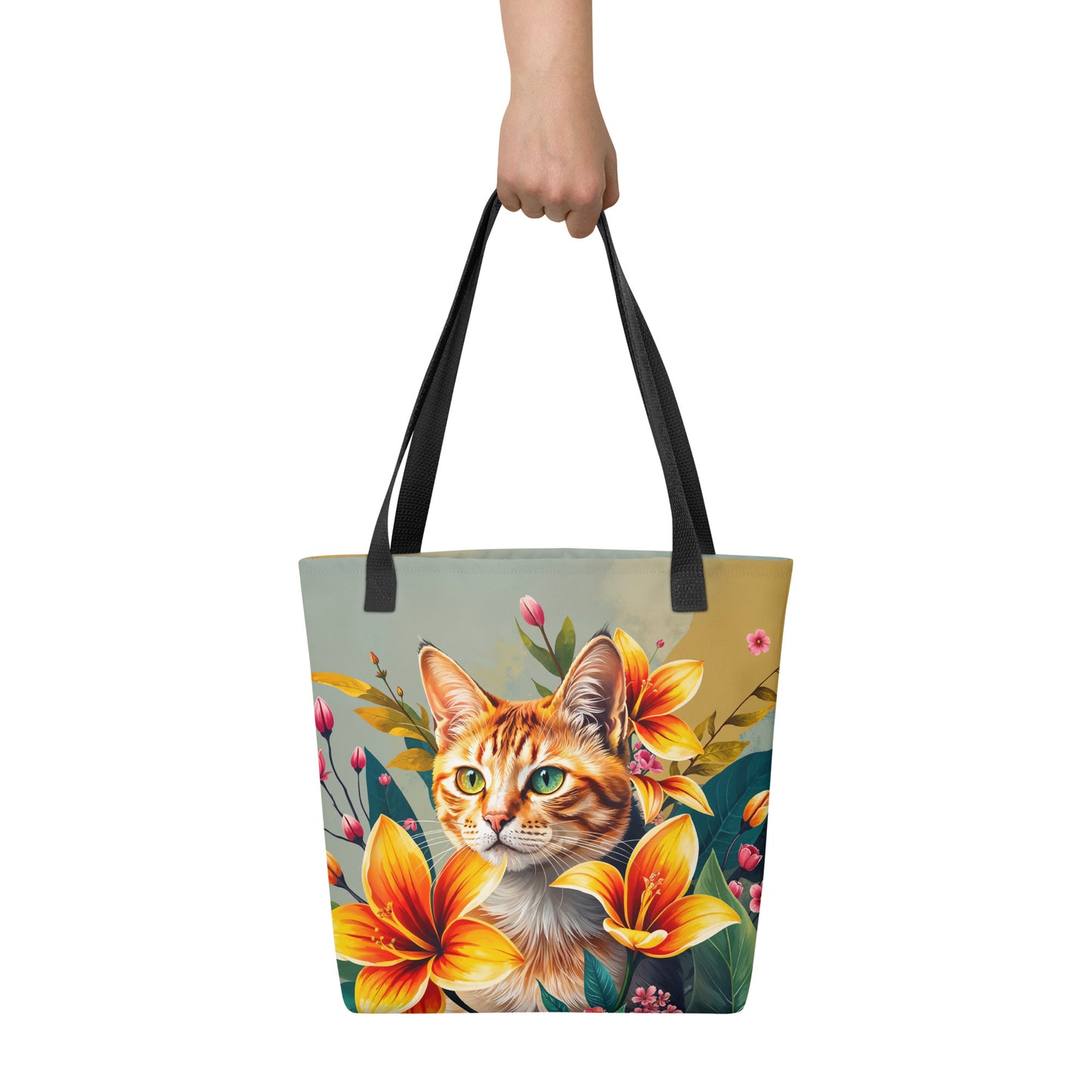 Tote bag with a cat and floral design held by a hand on a white background