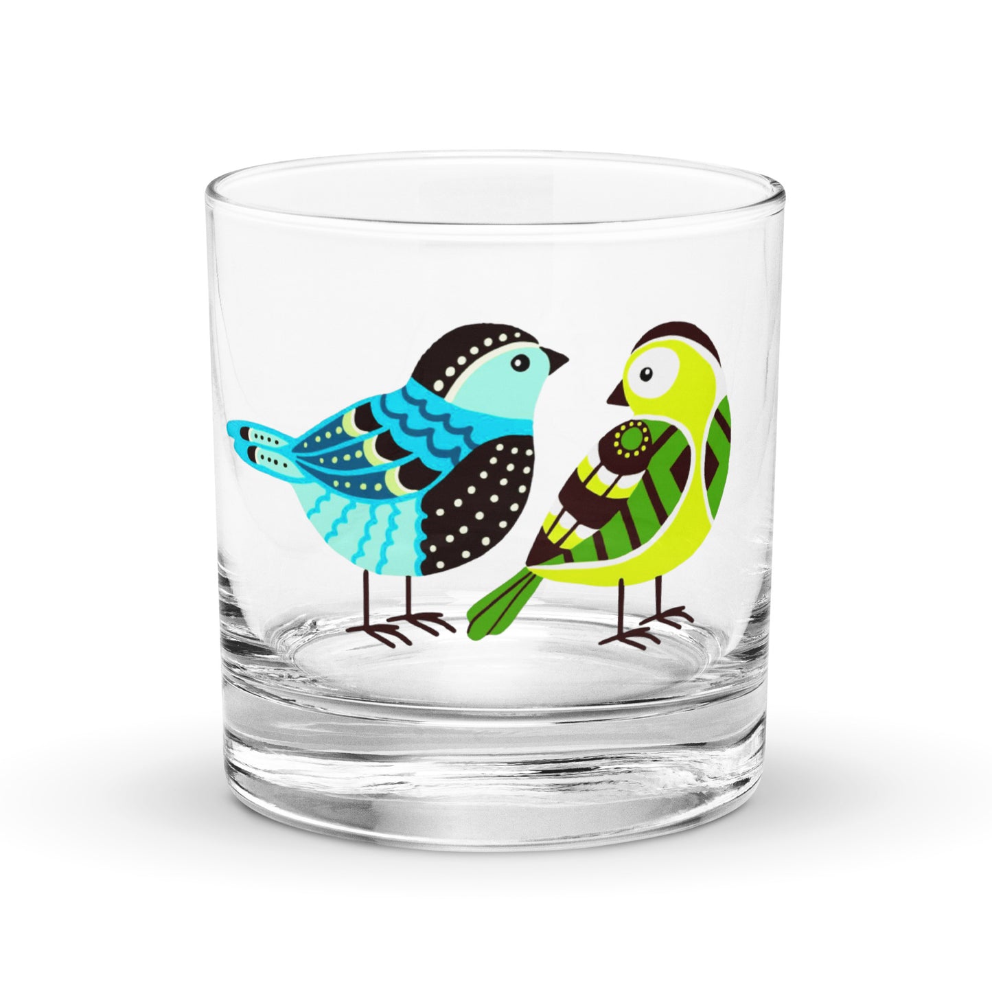 blue and green coloured birds on a whisky tumbler