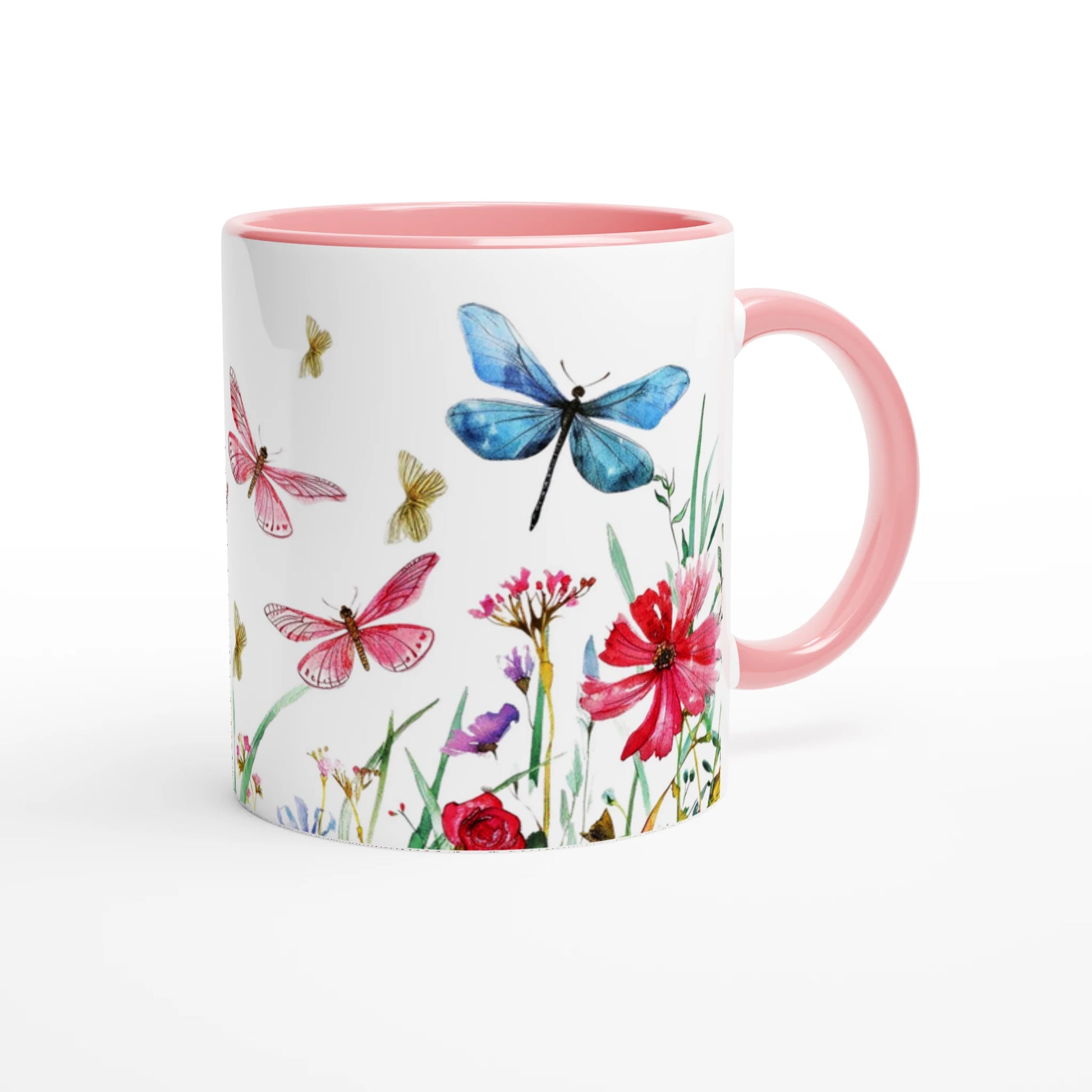 dragonflies and wild flowers design on a white coffee mug with pink handle