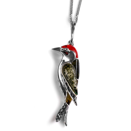 woodpecker design necklace pendant in silver coral and amber on a white background