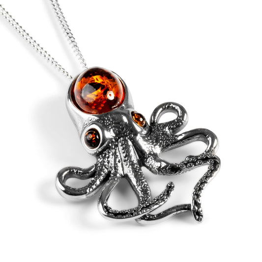 octopus design pendant necklace in silver and amber on a white background