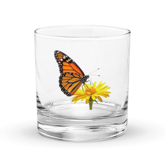monarch butterfly on a yellow flower decorating a whisky tumbler
