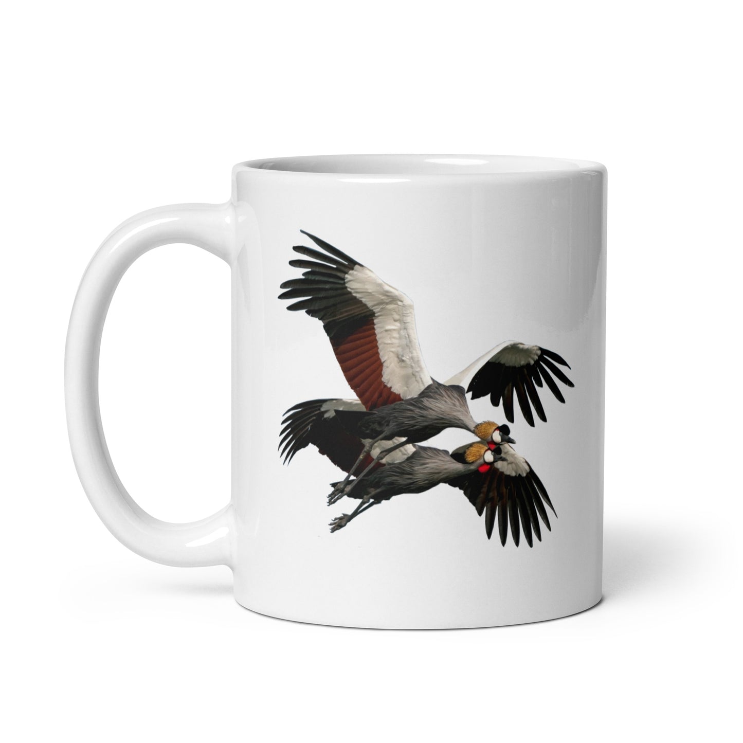 White glossy mug printed with a pair of crowned cranes in flight